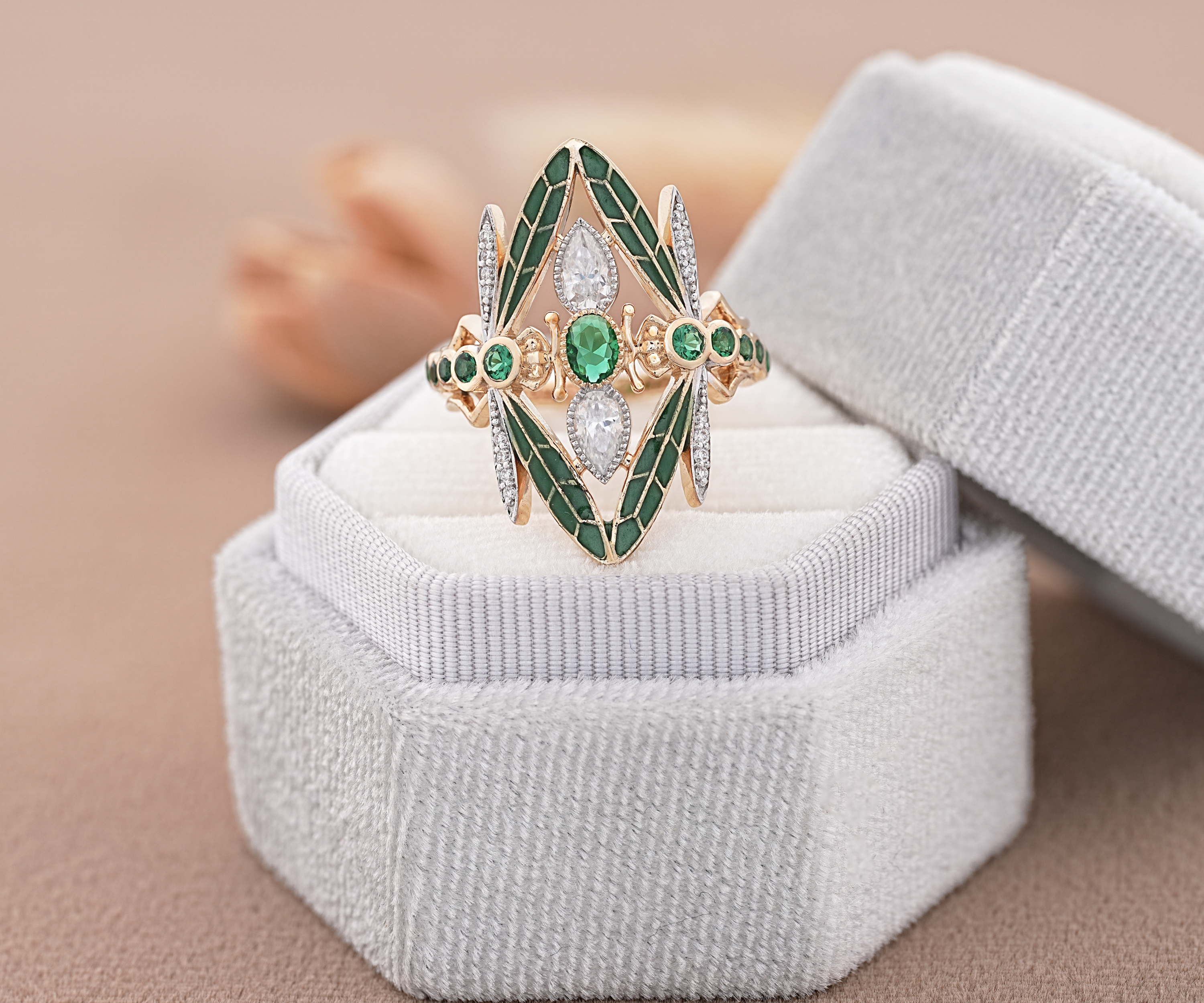 Gold ring with green gemstones