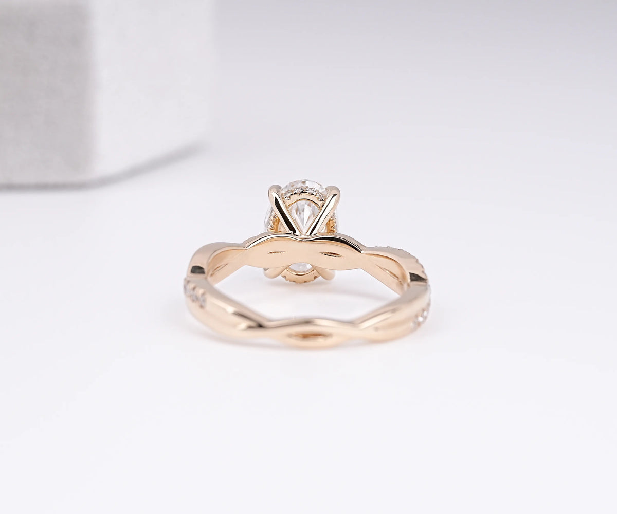 Oval cut lab diamond crossed band engagement ring with halo