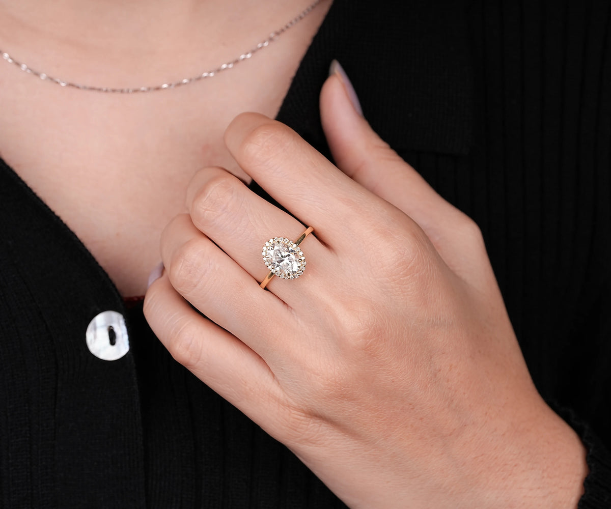Oval lab diamond four prong halo engagement ring
