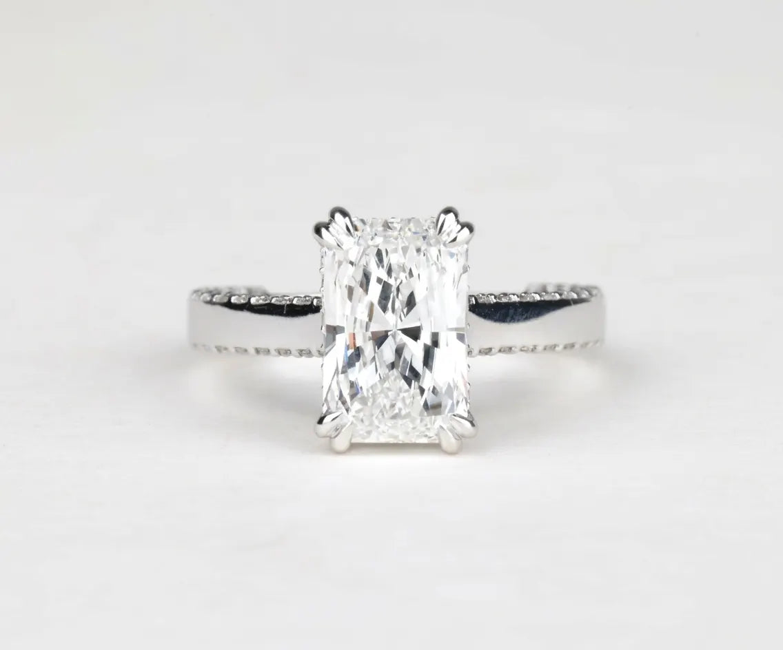 Radiant cut lab grown diamond cathedral engagement ring with hidden halo