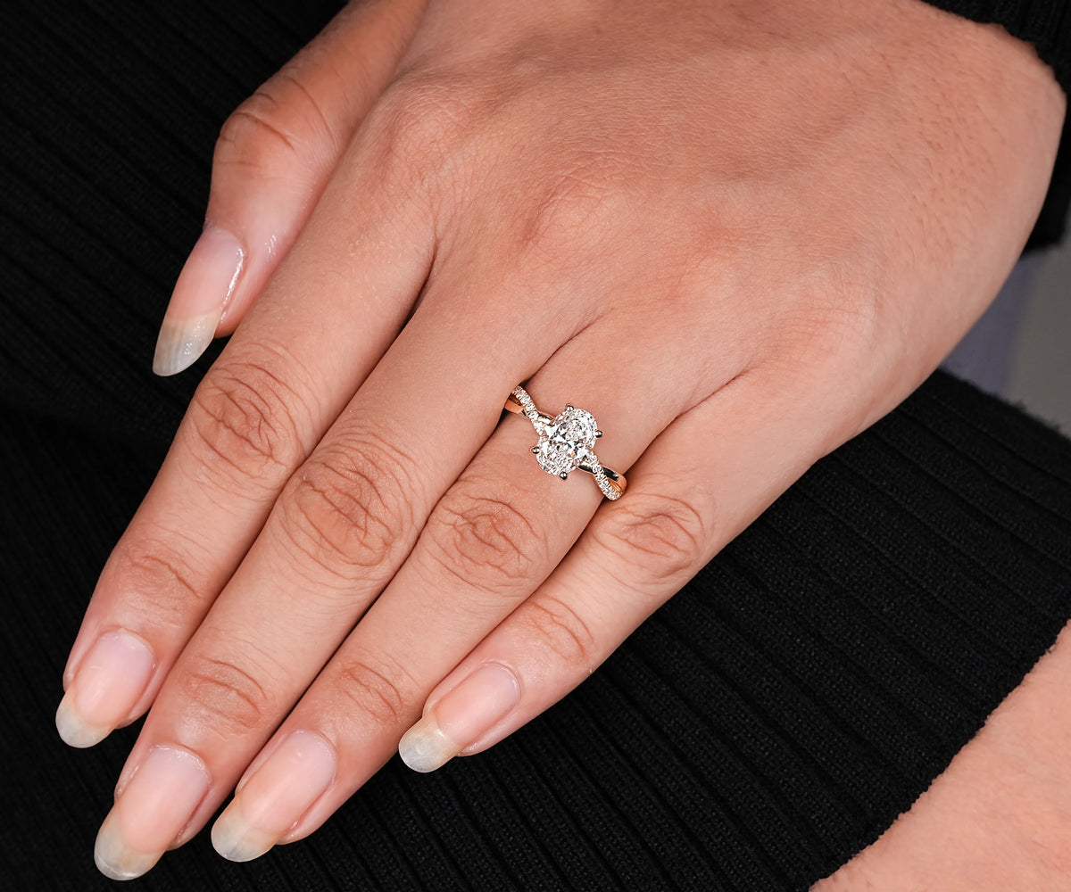 Twisted oval lab grown diamond solitaire with secret halo