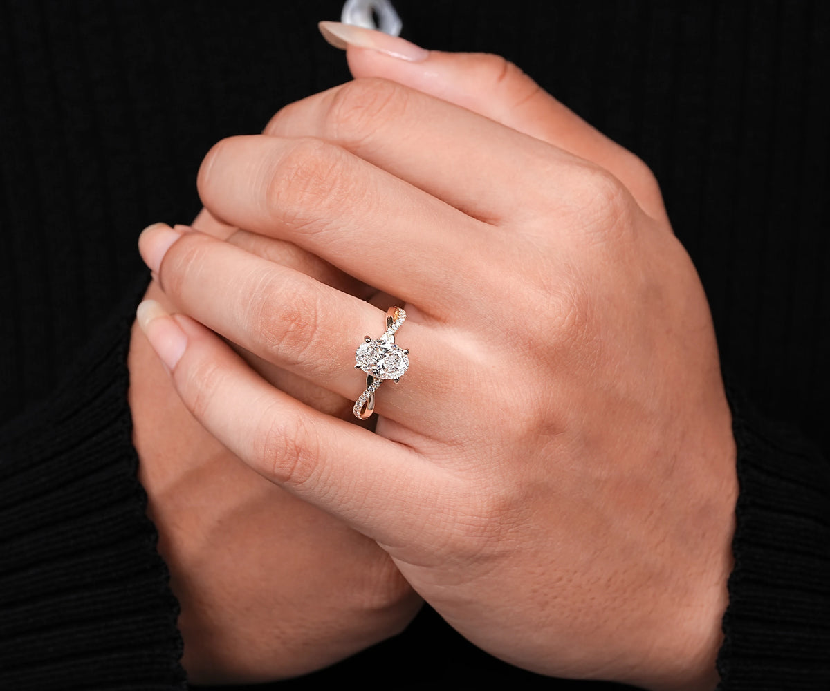 Twisted shank oval lab diamond engagement ring with hidden halo